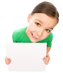 Image showing Happy little girl is holding blank board