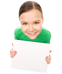 Image showing Happy little girl is holding blank board