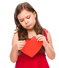 Image showing Portrait of a sad little girl in red