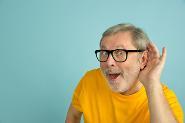 Image showing Caucasian senior man\'s portrait isolated on blue studio background