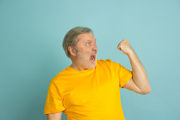 Image showing Caucasian senior man\'s portrait isolated on blue studio background