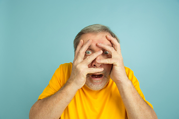 Image showing Caucasian senior man\'s portrait isolated on blue studio background