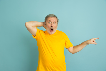 Image showing Caucasian senior man\'s portrait isolated on blue studio background