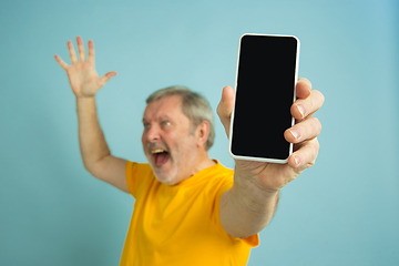 Image showing Caucasian senior man\'s portrait isolated on blue studio background