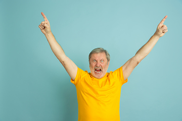 Image showing Caucasian senior man\'s portrait isolated on blue studio background