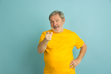 Image showing Caucasian senior man\'s portrait isolated on blue studio background