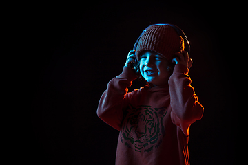 Image showing Caucasian boy\'s portrait isolated on dark studio background in neon light