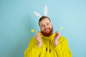 Image showing Easter bunny man with bright emotions on blue studio background