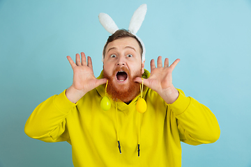 Image showing Easter bunny man with bright emotions on blue studio background