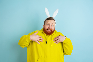 Image showing Easter bunny man with bright emotions on blue studio background