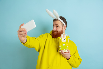 Image showing Easter bunny man with bright emotions on blue studio background