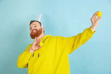 Image showing Easter bunny man with bright emotions on blue studio background