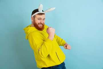 Image showing Easter bunny man with bright emotions on blue studio background