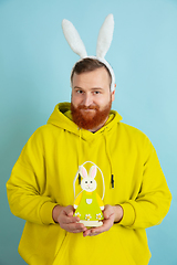 Image showing Easter bunny man with bright emotions on blue studio background