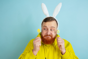 Image showing Easter bunny man with bright emotions on blue studio background