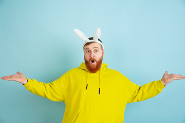 Image showing Easter bunny man with bright emotions on blue studio background