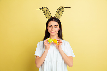 Image showing Easter bunny woman with bright emotions on yellow studio background