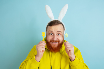 Image showing Easter bunny man with bright emotions on blue studio background