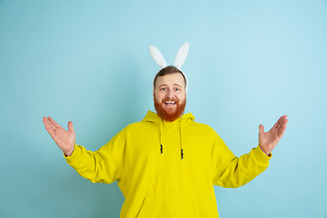 Image showing Easter bunny man with bright emotions on blue studio background