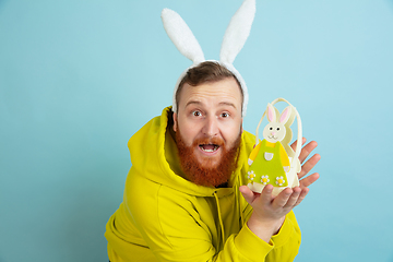 Image showing Easter bunny man with bright emotions on blue studio background