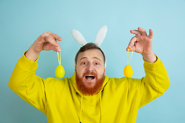 Image showing Easter bunny man with bright emotions on blue studio background