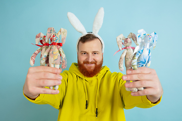 Image showing Easter bunny man with bright emotions on blue studio background