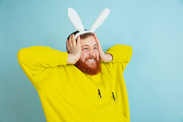 Image showing Easter bunny man with bright emotions on blue studio background