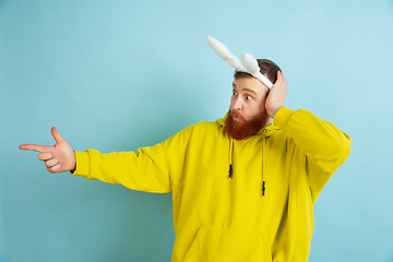 Image showing Easter bunny man with bright emotions on blue studio background