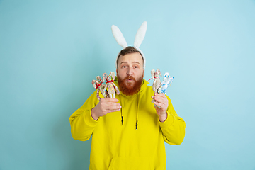 Image showing Easter bunny man with bright emotions on blue studio background