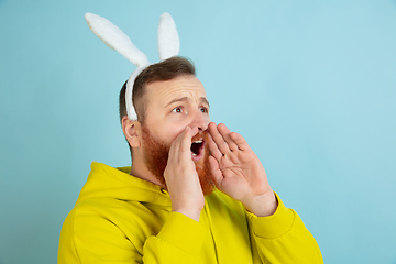 Image showing Easter bunny man with bright emotions on blue studio background