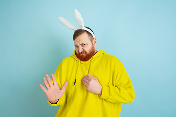 Image showing Easter bunny man with bright emotions on blue studio background