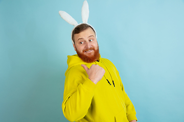 Image showing Easter bunny man with bright emotions on blue studio background