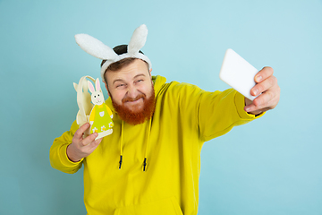 Image showing Easter bunny man with bright emotions on blue studio background