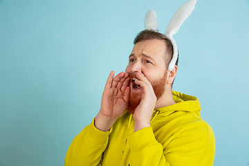 Image showing Easter bunny man with bright emotions on blue studio background