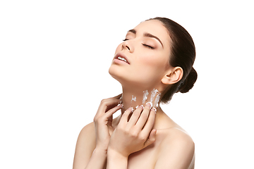 Image showing girl applying moisturizing cream isolated on white