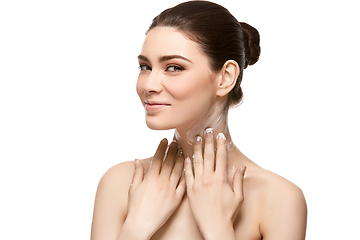 Image showing girl applying moisturizing cream isolated on white