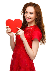 Image showing Young woman holding red heart