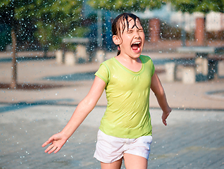 Image showing Girl is running through fountains