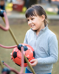 Image showing Cute little girl is playing in playground