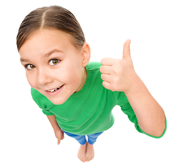 Image showing Little girl is showing thumb up gesture