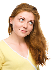 Image showing Young happy woman is looking up and smile