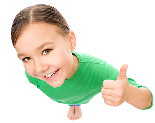 Image showing Little girl is showing thumb up gesture