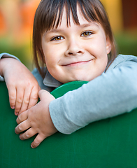 Image showing Cute little girl is playing in playground