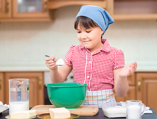 Image showing Girl is cooking in kitchen