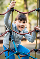 Image showing Cute little girl is playing in playground