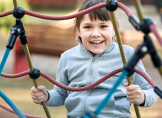 Image showing Cute little girl is playing in playground