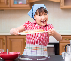 Image showing Girl is cooking in kitchen