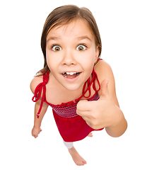 Image showing Little girl is showing thumb up gesture