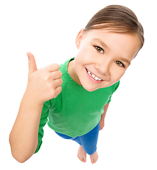 Image showing Little girl is showing thumb up gesture