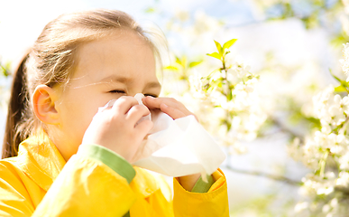 Image showing Little girl is blowing her nose